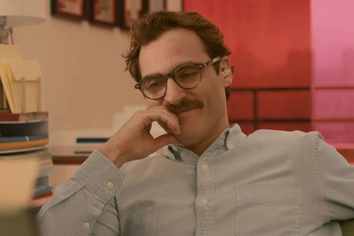 Theodore smiling as he listens to Samantha through his earpiece