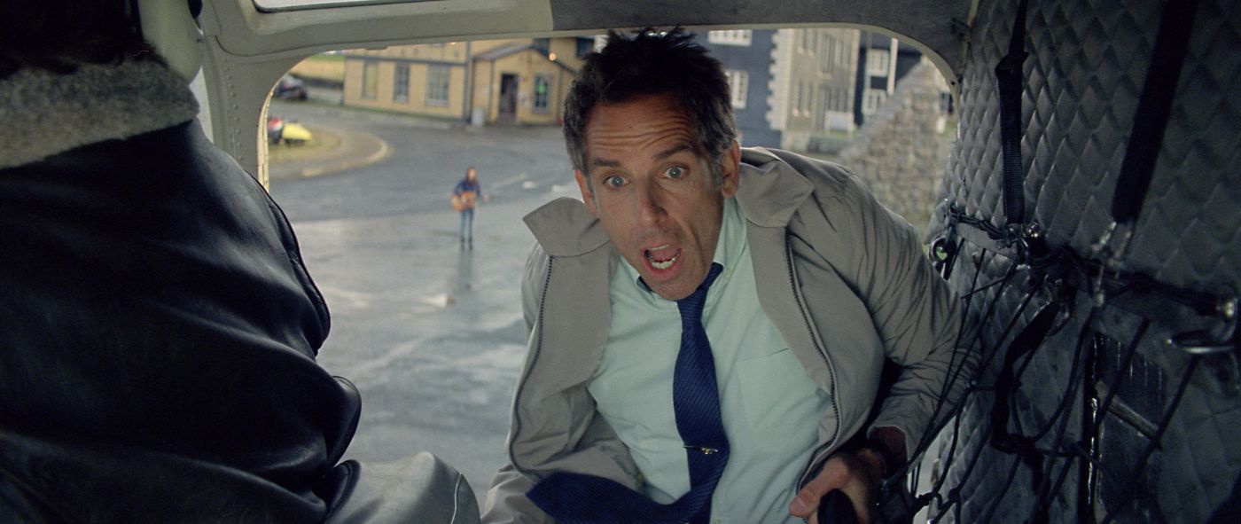 Walter holding the open door of a helicopter as he commits to the journey