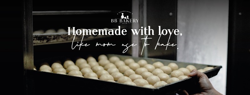 BB Bakery Homemade with love artwork showing a baker holding a tray of dough beside an oven